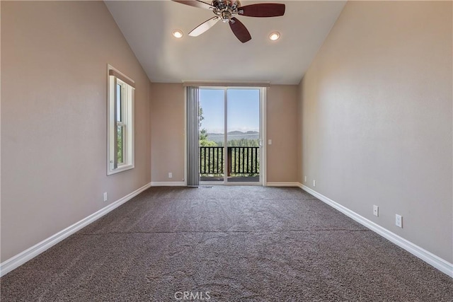 unfurnished room featuring carpet, ceiling fan, and lofted ceiling