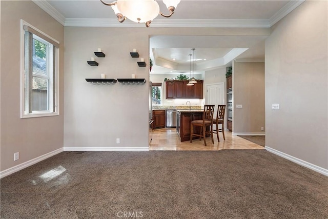 27554 N Bay Rd, Lake Arrowhead, CA 92352 - kitchen with appliances with stainless steel finishes, ornamental molding, light colored carpet, a kitchen island with sink, and light countertops