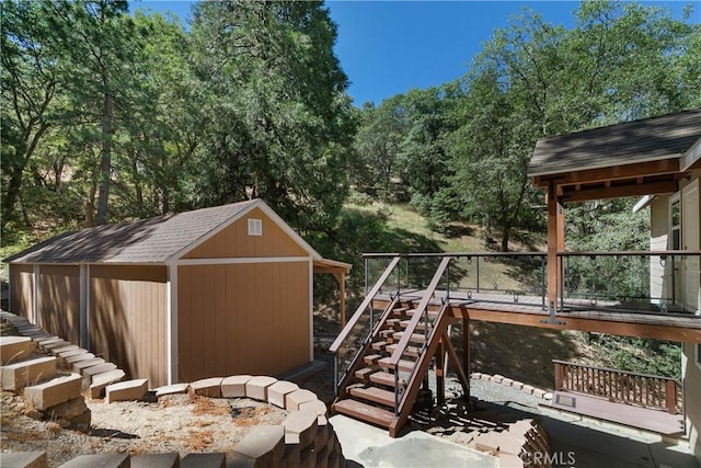 27554 N Bay Rd, Lake Arrowhead, CA 92352 - wooden deck featuring stairway, a storage shed, and view of scattered trees