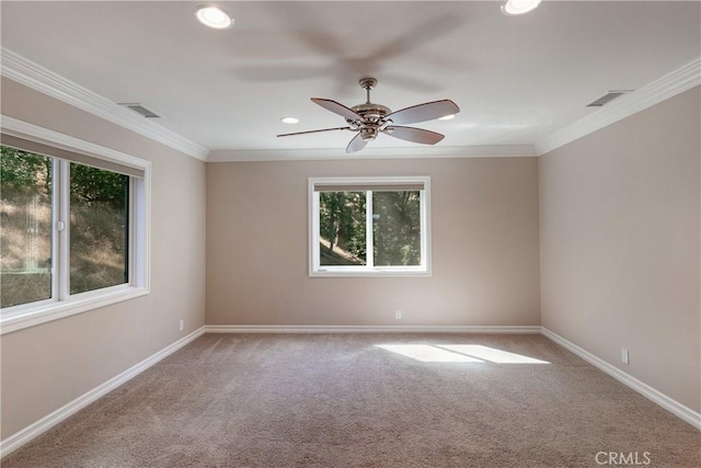 empty room with carpet floors, a healthy amount of sunlight, and ornamental molding