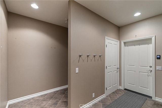 doorway with dark tile patterned flooring