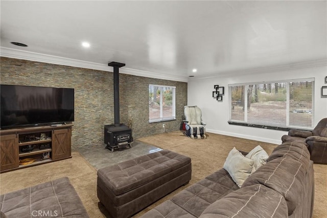 carpeted living room featuring a wood stove and crown molding