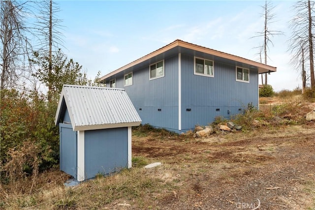 view of home's exterior featuring a storage unit