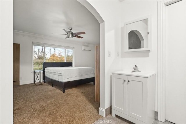 carpeted bedroom with an AC wall unit, ceiling fan, and ornamental molding