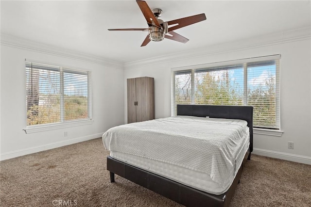 carpeted bedroom with ceiling fan, crown molding, and multiple windows