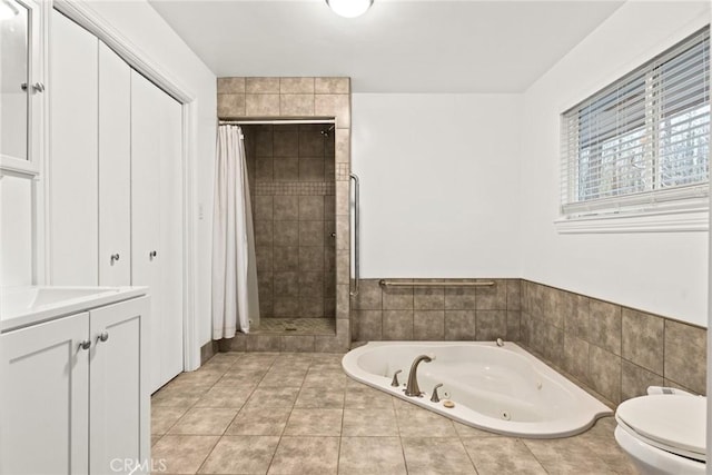 bathroom with toilet, tile patterned flooring, and shower with separate bathtub