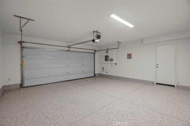 garage with a garage door opener and electric panel