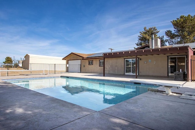 view of pool featuring a patio and a diving board