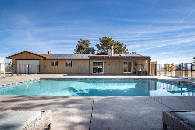 view of pool featuring a patio and central AC unit