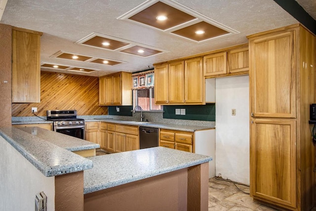 kitchen featuring light stone countertops, kitchen peninsula, sink, black dishwasher, and stainless steel stove