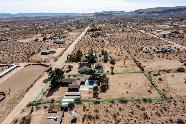 birds eye view of property with a mountain view