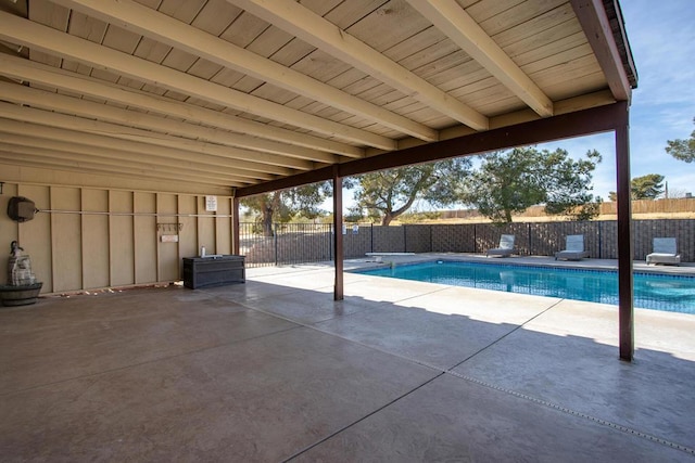 view of pool featuring a diving board and a patio area