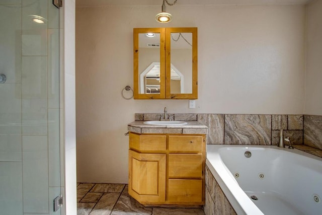 bathroom featuring vanity and independent shower and bath