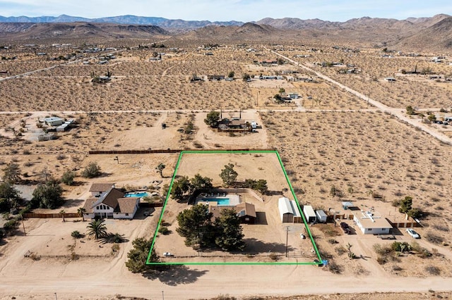 birds eye view of property with a mountain view