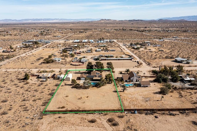 birds eye view of property featuring a mountain view