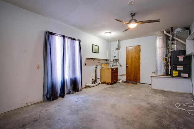 miscellaneous room featuring concrete floors, ceiling fan, and water heater