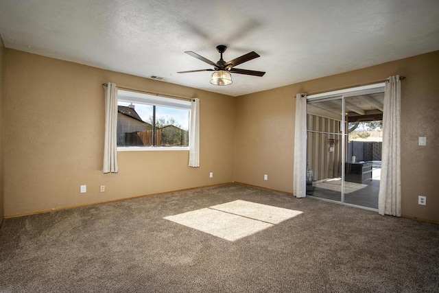 unfurnished bedroom featuring carpet, ceiling fan, access to outside, and multiple windows