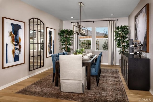 dining space with a notable chandelier and light wood-type flooring