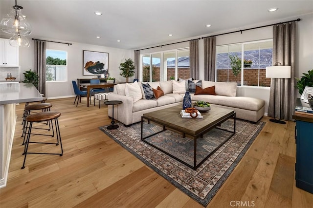 living room featuring light wood-type flooring and a wealth of natural light