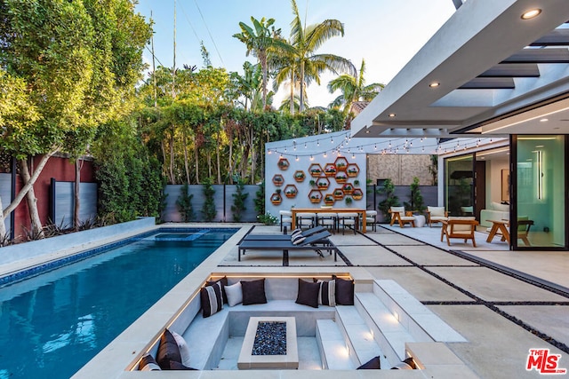 view of pool featuring a patio and an outdoor fire pit