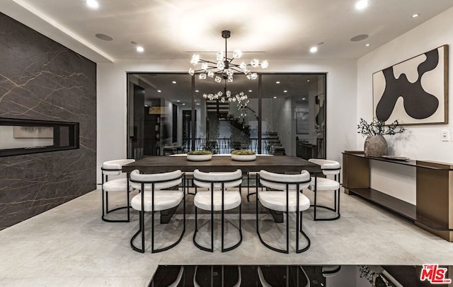 dining area featuring tile walls and a chandelier