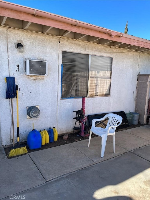 view of patio / terrace with an AC wall unit