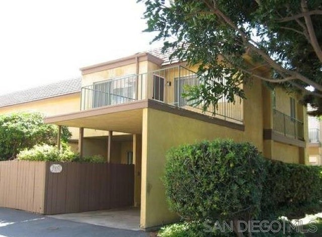 view of side of home featuring a balcony