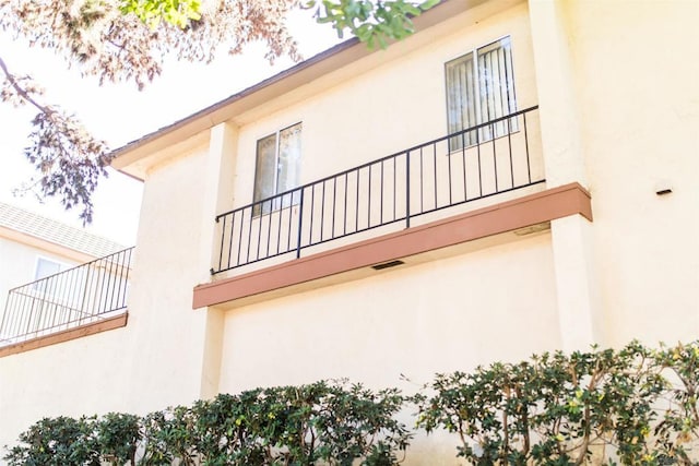 view of side of property with a balcony