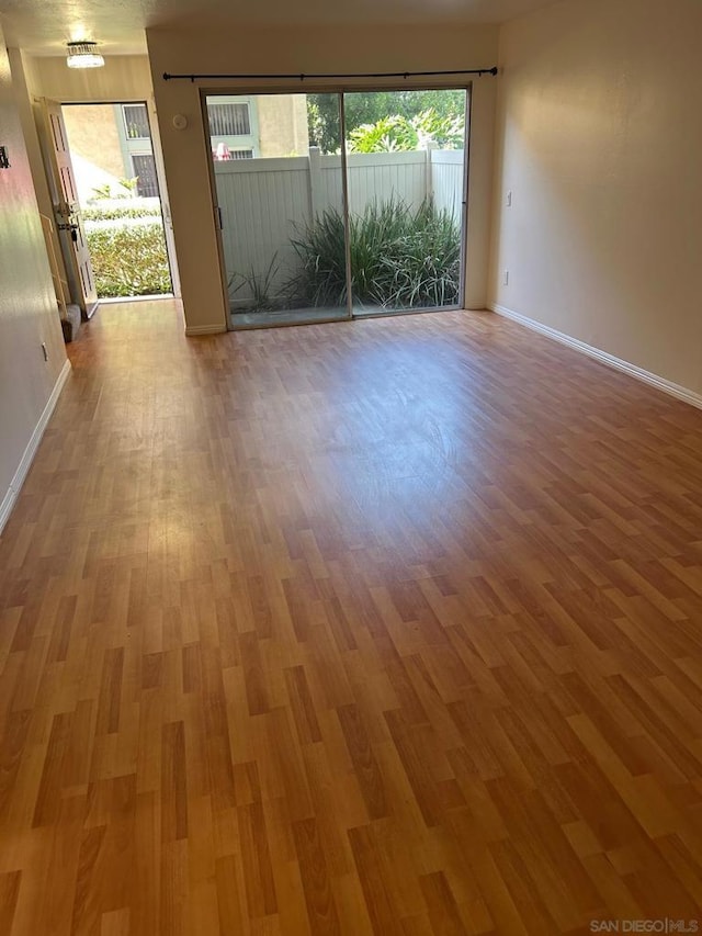 empty room featuring hardwood / wood-style flooring and a healthy amount of sunlight