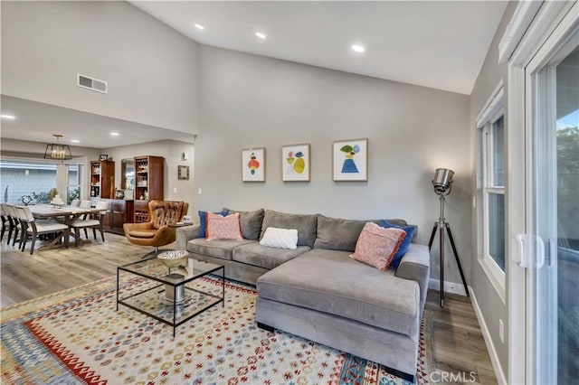 living room with hardwood / wood-style flooring and lofted ceiling