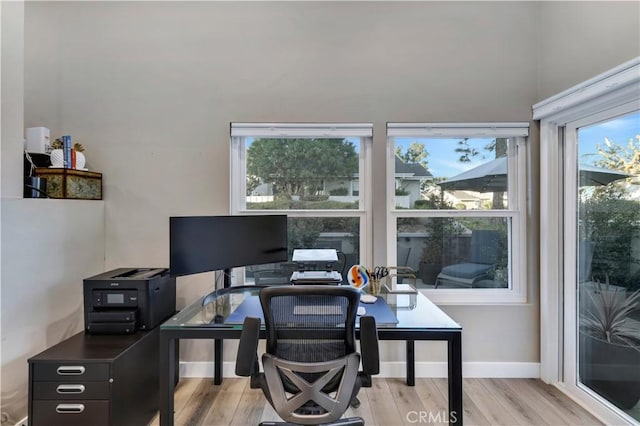 office area with a healthy amount of sunlight and light hardwood / wood-style floors