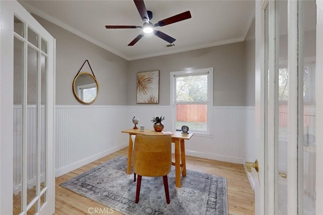 home office with french doors, light hardwood / wood-style flooring, ceiling fan, and ornamental molding