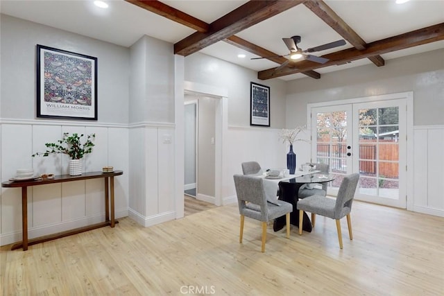 dining area with beam ceiling, light hardwood / wood-style flooring, and french doors