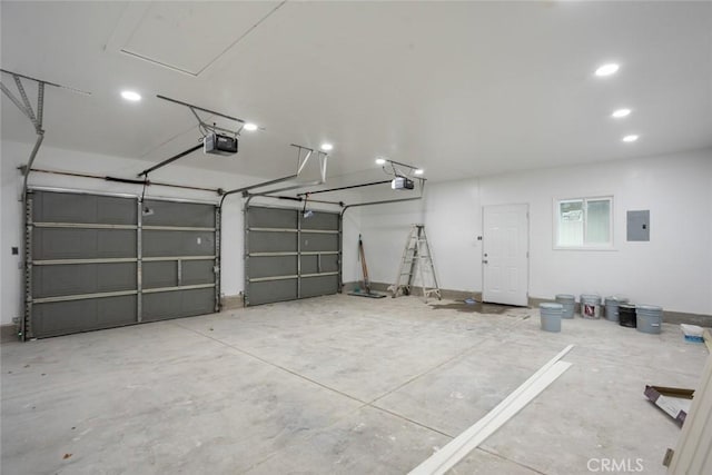 garage with electric panel and a garage door opener