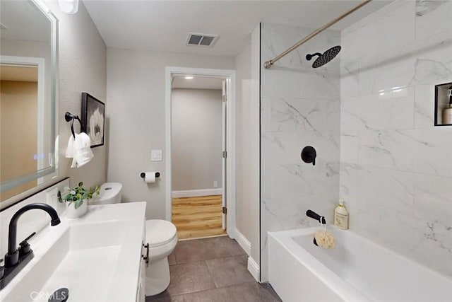 full bathroom with tile patterned floors, vanity, toilet, and tiled shower / bath