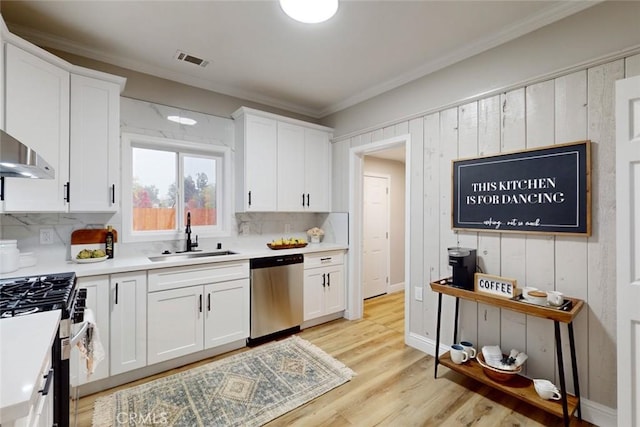 kitchen featuring sink, white cabinets, light hardwood / wood-style floors, and appliances with stainless steel finishes