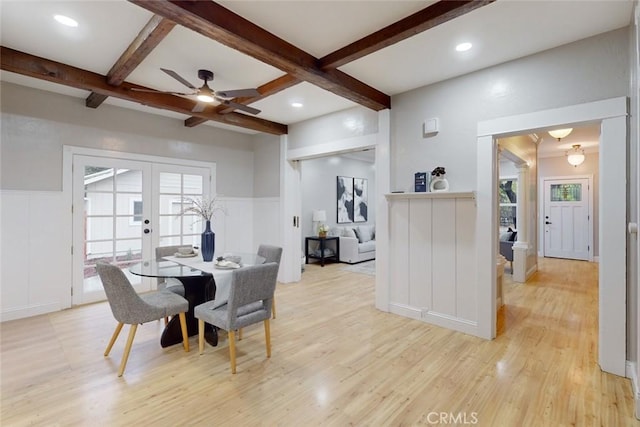 dining space featuring french doors, coffered ceiling, ceiling fan, beam ceiling, and light hardwood / wood-style floors