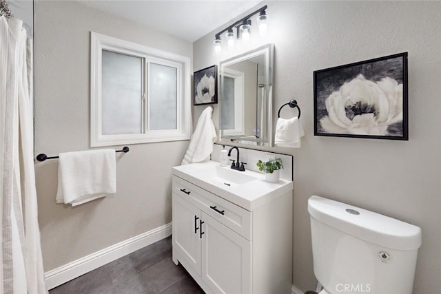 bathroom with tile patterned floors, vanity, and toilet