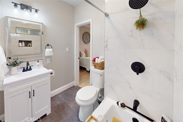 bathroom with vanity, toilet, and tiled shower