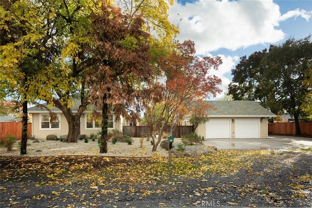 view of property hidden behind natural elements with a garage