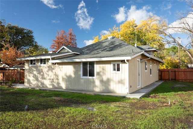 rear view of property with a lawn