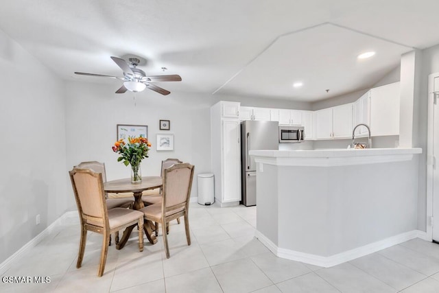 kitchen with white cabinetry, sink, ceiling fan, light tile patterned floors, and appliances with stainless steel finishes