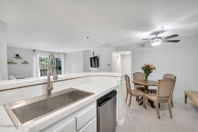 kitchen with dishwasher, white cabinets, sink, ceiling fan, and light tile patterned floors