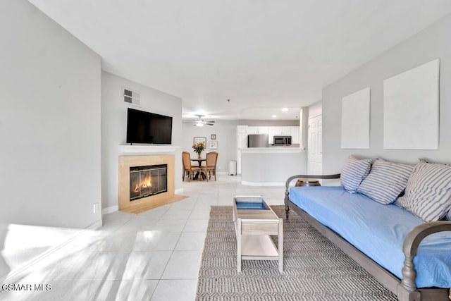 living room featuring light tile patterned floors and ceiling fan