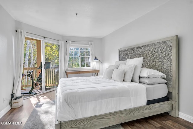 bedroom with access to outside and dark hardwood / wood-style floors