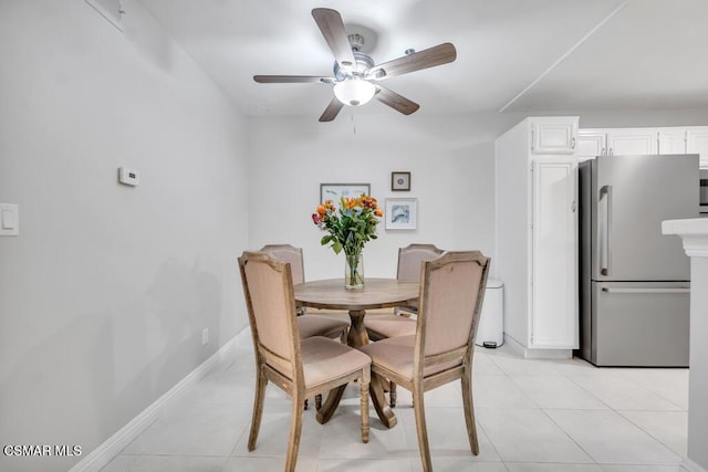 tiled dining area with ceiling fan