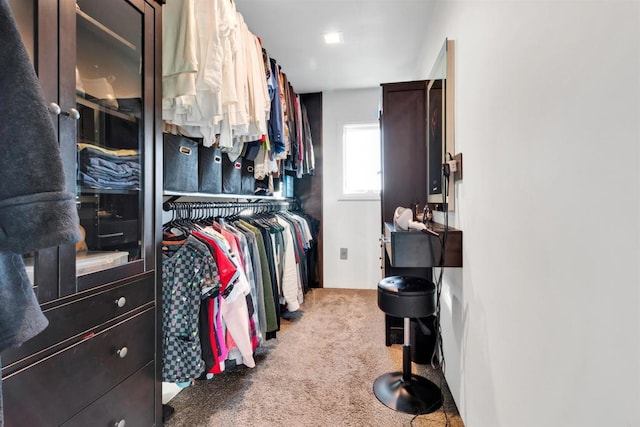 walk in closet featuring light colored carpet