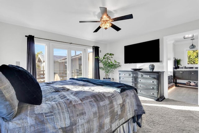 bedroom featuring ceiling fan, light colored carpet, and access to outside