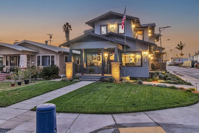 craftsman house featuring a porch and a yard