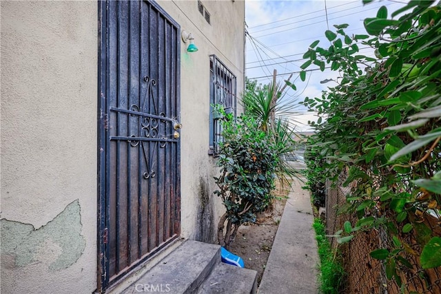 property entrance with stucco siding